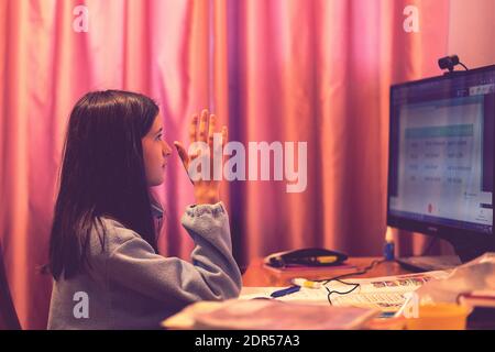 Smart preteen schoolgirl doing her homework with digital tablet at home. Child using gadgets to study. Education and learning for kids. Homeschooling Stock Photo