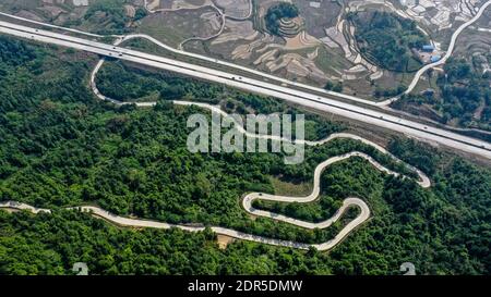 (201220) -- BEIJING, Dec. 20, 2020 (Xinhua) -- Aerial photo taken on April 15, 2020 shows a section of an expressway linking Sanjiang Dong Autonomous County and Liuzhou City, south China's Guangxi Zhuang Autonomous Region.Improving rural road infrastructure has been accredited for accelerating Guangxi's poverty relief campaign. A full-coverage rural highway network connecting townships and administrative villages by tarmac or cement roads has been set up in Guangxi. China has made great achievements in poverty relief that has impressed the world, with almost 100 million people lifted out of po Stock Photo