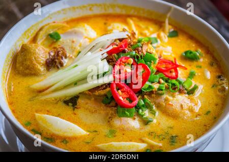 A Bowl Of Laksa Rice Noodles In Mild Curry Gravy With Hard Boiled Egg Bean Sprouts Scallions Tofu Puffs And Fish Cake Stock Photo Alamy