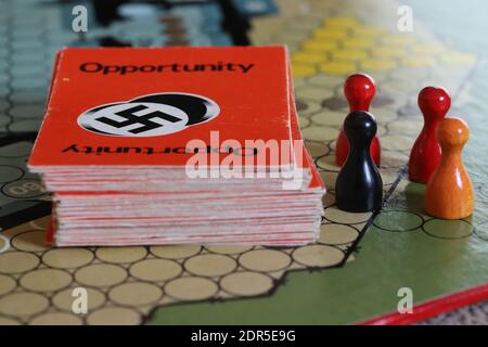 UK - Escape from Colditz board game from the 1970s. Opportunity cards and black, red and orange playing pieces. Stock Photo
