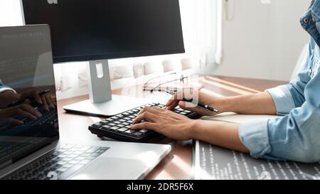 Software developer or programmer working data debugging improvement binary algorithm on desktop pc in a software develop company office Stock Photo