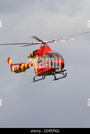 Essex and Herts air ambulance landing in a field for and emergency rescue after an accident Stock Photo