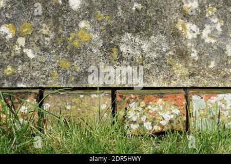 Old bricks, stone, and grass background. Stock Photo