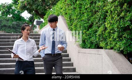 Two Business Colleagues Having Discussion new project business meeting outside office in an urban setting. Stock Photo
