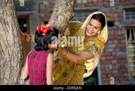 Mother with girl playing hide and seek Stock Photo