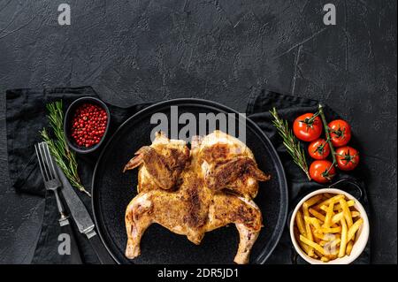 Hot Fried Chicken tobacco with herbs and garlic. Black background. Top view. Space for text. Stock Photo