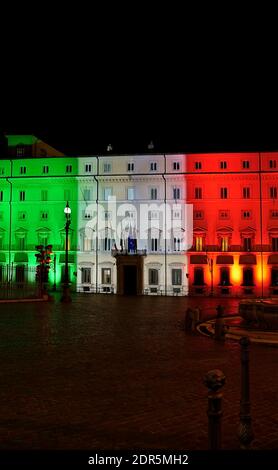 Italian tricolor flag projected on the illuminated facade of Chigi Palace, seat of the Presidency of the Council of Ministers. Rome, Italy, Europe, EU Stock Photo