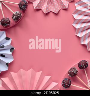 Decorative square frame with text space. Cake pops covered with chocolate and colored sugar icing. Creative monochrome flat lay on pink paper decorate Stock Photo