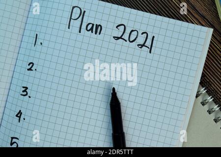 Plan 2021 write on a book isolated isolated on Wooden Table. Business concept Stock Photo