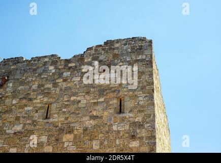 Gezlevsky gate in Evpatoria. The ancient masonry of the fortress against the blue sky. Shell brick. Stock Photo