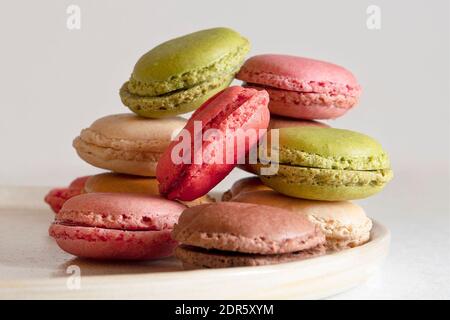 Assortments of coloured macaroons stacked on a plate Stock Photo