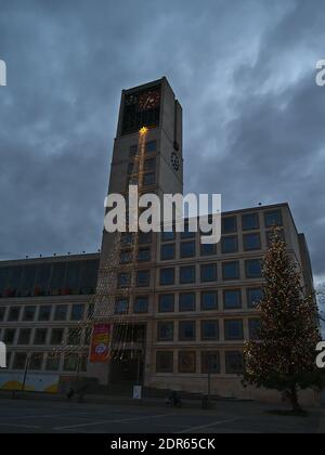 Town hall of Stuttgart with bell tower located at market place in downtown during Christmas season with decorations and Christmas tree and cloudy sky. Stock Photo