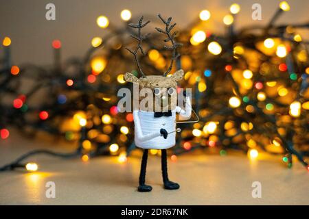 Christmas lights bokeh with a deer figure made of champagne cork creative cork figure creative Christmas home deco Recycled Christmas Stock Photo