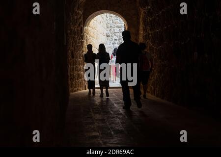 Back rear view of silhouette of people leave the arch door to the street Stock Photo
