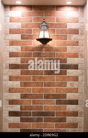 decorative wall with brickwork tiles and vintage retro lamp. Renovation and decoration of premises Stock Photo