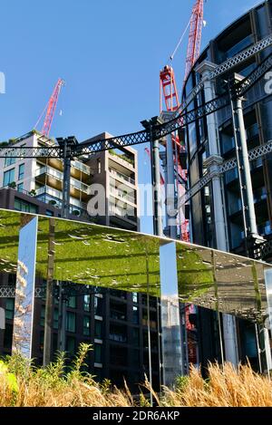 Gasholders London apartment development in Kings Cross. Cast-iron former gasholder frames refurbished for luxury flats and city living with canal view Stock Photo