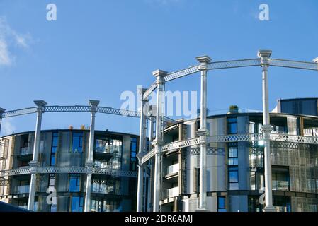 Gasholders London apartment development in Kings Cross. Cast-iron former gasholder frames refurbished for luxury flats and city living with canal view Stock Photo