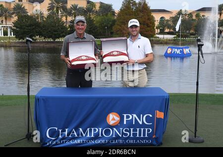 Orlando, United States. 20th Dec, 2020. December 20, 2020 - Orlando, Florida, United States - Justin Thomas (right) and his father, Mike, pose with the Willie Park trophy after winning the 2020 PNC Championship golf tournament at the Ritz-Carlton Golf Club on December 20, 2020 in Orlando, Florida. The team shot 25 under for the tournament and 15 under during Sunday's second round. Credit: Paul Hennessy/Alamy Live News Stock Photo