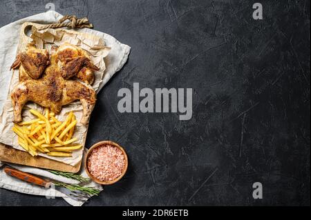 Hot Fried Chicken tobacco with herbs and garlic. Black background. Top view. Space for text. Stock Photo