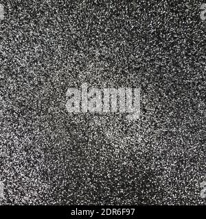 Black Glitter background. Brilliant dust abstract surface. Shimmer hologram crystal texture. Holiday sparkle backdrop. Stock Photo