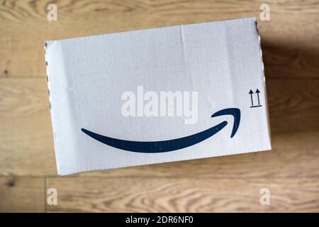 Amazon package box isolated on wooden floor background Stock Photo
