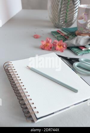 Empty spiral notebook with a dotted pencil at the top of it. Stock Photo