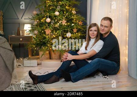 Beautiful family with christmas tree in the living room Stock Photo