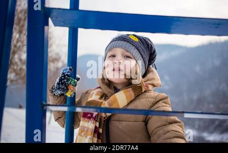 Little boy having fun, playing outside in cold weather. Wintertime, healthy kids activity concept Stock Photo
