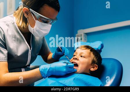 Dentist Operating Boy In Medical Clinic