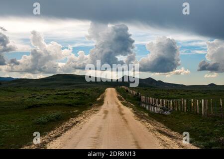 Stormcoulds rise above Old Highway 68 along the Camas Prairie in Idaho's Bennett Foothills. Stock Photo