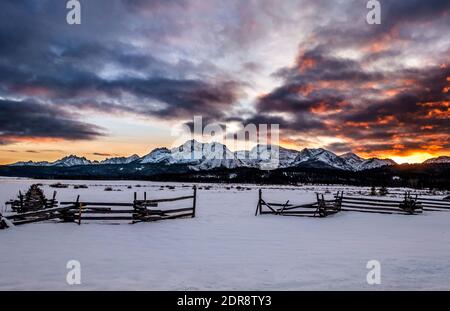 Winter sunset with rail fence in foreground and Sawtooth Mts in background Stock Photo
