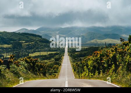 High Angle View Of Empty Road Leading Towards Mountains Against Sky