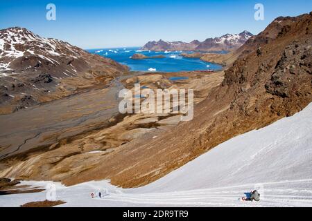 The end of the Shackleton hike at Stromness Bay, South Georgia Island, with icebergs from A-38 iceberg Stock Photo