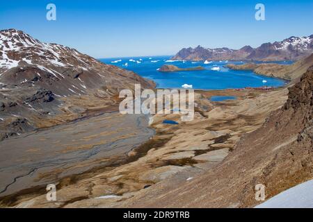 The end of the Shackleton hike at Stromness Bay, South Georgia Island, with icebergs from A-38 iceberg Stock Photo