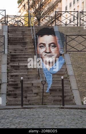 Deux artistes de street art, Zag et Sia réalisent une fresque par anamorphose représentant Coluche sur un escalier prés de la rue Gazan dans le 14eme arrondissement de Paris ou le comique a vécu pendant une douzaine d?années. Le projet veut rappeler qu?il y a 30 ans les Restos du C?ur servaient leurs premiers repas. La police, prévenue par des riverains est venue verifier la légalité du projet ( validé par par le maire d'arrondissement). Paris, France le 31 décembre 2015. Photo by Christophe Geyres/ABACAPRESS.COM Stock Photo