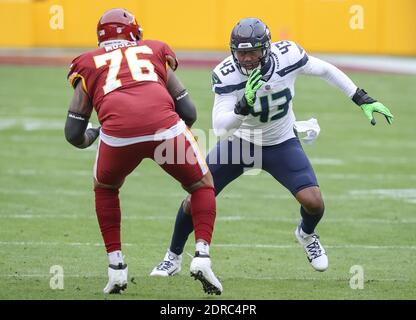 Seattle Seahawks defensive end Carlos Dunlap is pictured with an decal on  his helmet reading end racism before an NFL football game, Thursday, Oct.  7, 2021, in Seattle. The Rams won 26-17. (