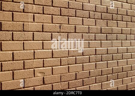 Full frame texture background of a textured beige painted exterior brick wall surface with a mild grungy look for normal weathering Stock Photo