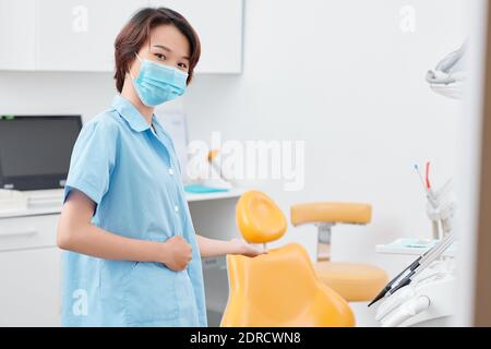 Inviting patient in dental chair Stock Photo