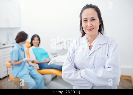 Confident smiling female dentist Stock Photo