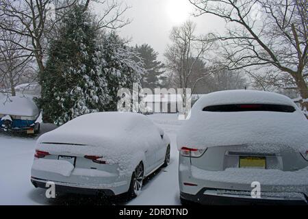 Looking at snow falling on street and cars from the safety of a residential garage in a suburban town -04 Stock Photo