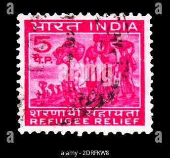 MOSCOW, RUSSIA - FEBRUARY 9, 2019: A stamp printed in India shows Compulsory supplement brand in favor of the refugees, Obligatory postal tax for Refu Stock Photo