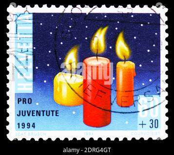 MOSCOW, RUSSIA - FEBRUARY 10, 2019: A stamp printed in Switzerland shows Christmas candles, Pro Juventute: Christmas candles, mushrooms of the forest