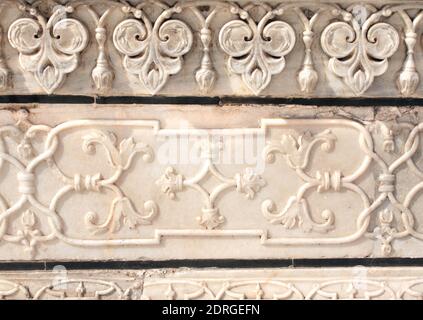 Detail of ancient floral bas-relief on marble. Ancient carving with flower ornament on marble in Taj Mahal, India Stock Photo