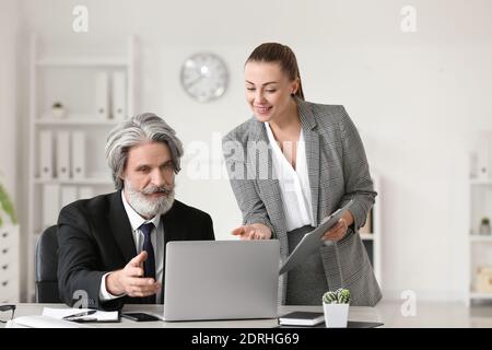 Senior businessman with his secretary in office Stock Photo