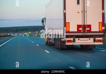 truck moves on country highway at night Stock Photo