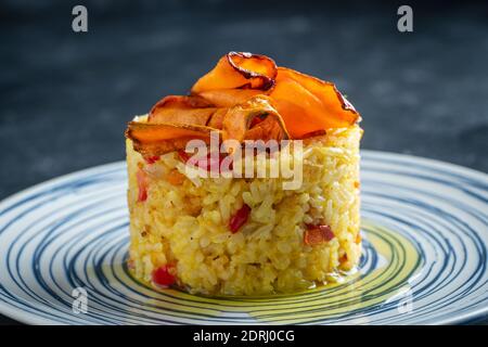 Boiled rice with fried red peppers, carrots and onions, close up. Food background. Healthy food Stock Photo