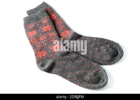 Pair of grey wool socks with orange pattern isolated on white Stock Photo