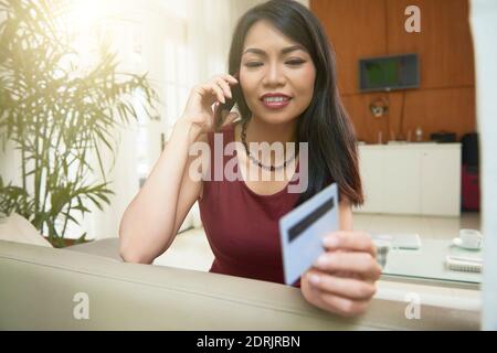 Talking on phone with bank manager Stock Photo