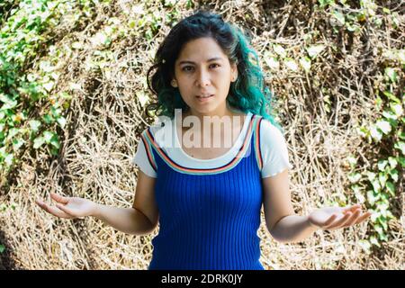 A shallow focus of a young Hispanic woman with a questioning expression on her face Stock Photo