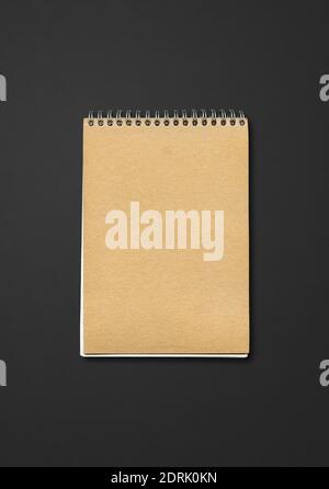 Spiral closed notebook mockup, brown paper cover, isolated on black background Stock Photo